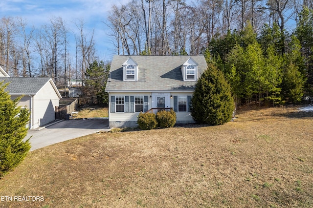 cape cod home with a front lawn