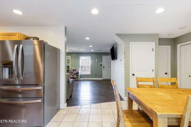 kitchen with light brown cabinetry, stainless steel fridge, and light tile patterned flooring