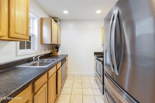 kitchen featuring appliances with stainless steel finishes, sink, and light tile patterned flooring