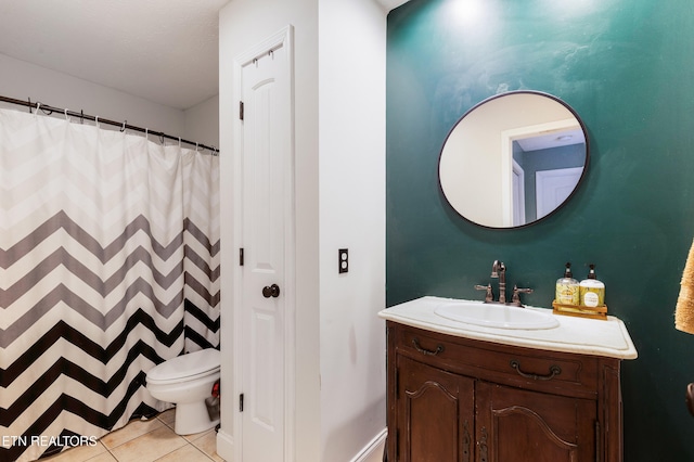 bathroom featuring toilet, vanity, and tile patterned flooring