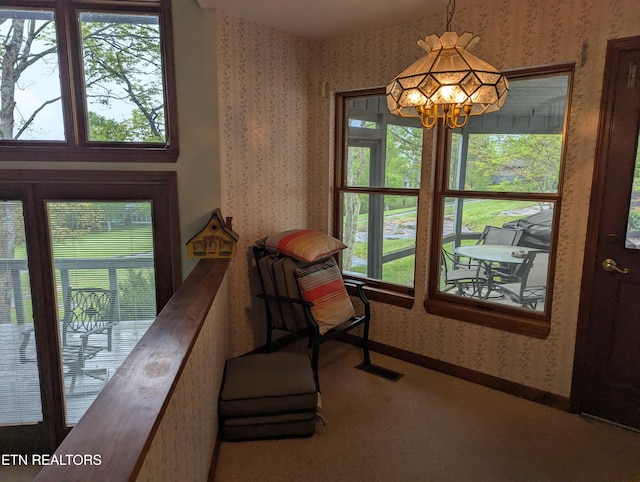 124 Sugarbush Cir, Crossville, TN 38558 - interior space with carpet flooring, wallpapered walls, a notable chandelier, and a healthy amount of sunlight