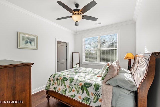 bedroom with crown molding, dark wood-type flooring, and ceiling fan