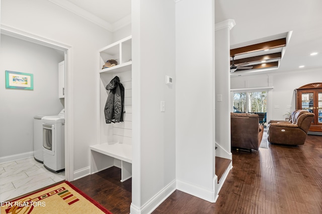 mudroom featuring ornamental molding and separate washer and dryer