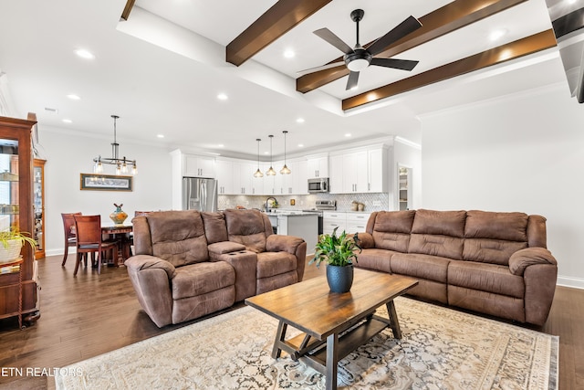 living room featuring crown molding, sink, dark hardwood / wood-style floors, and ceiling fan with notable chandelier