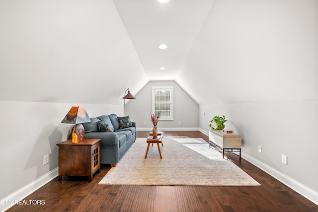 living room featuring vaulted ceiling and dark hardwood / wood-style floors