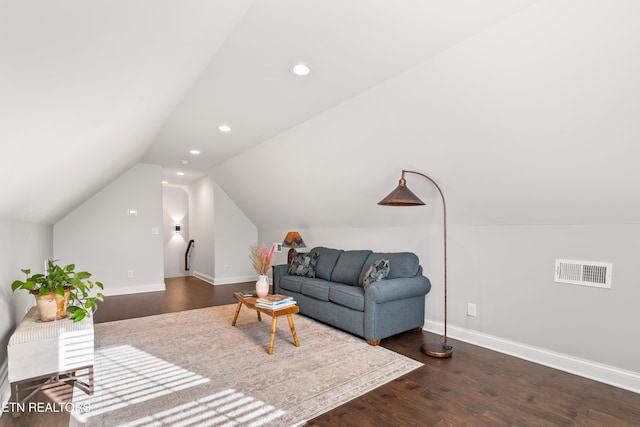 living room with dark wood-type flooring and vaulted ceiling