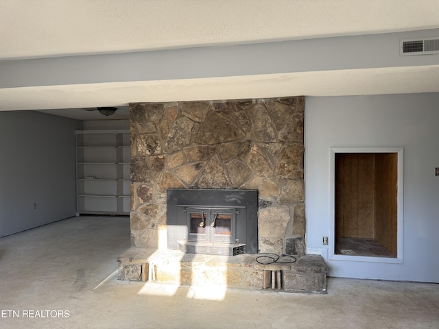 room details featuring visible vents and a textured ceiling