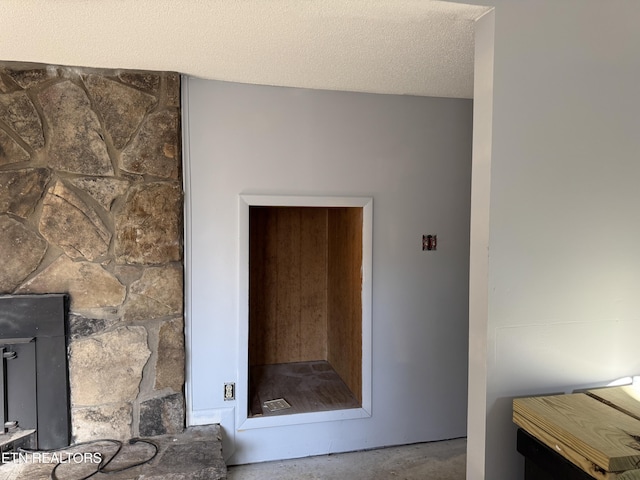 room details with a fireplace and a textured ceiling