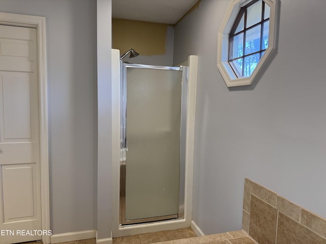 bathroom featuring walk in shower and tile patterned floors