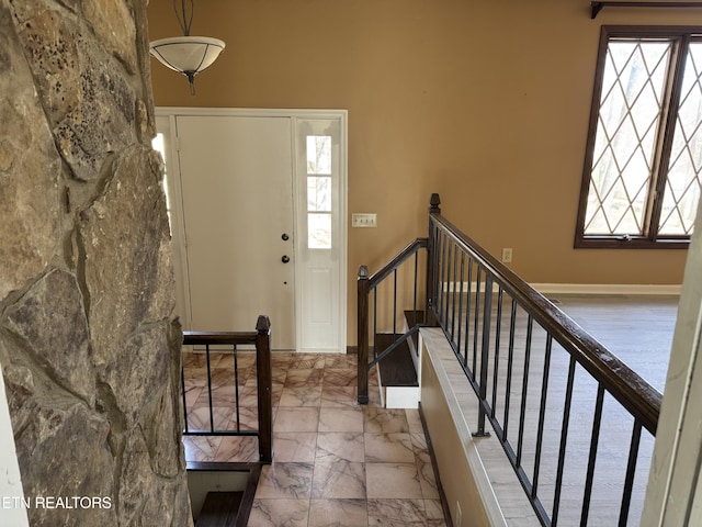 foyer entrance with marble finish floor and stairway