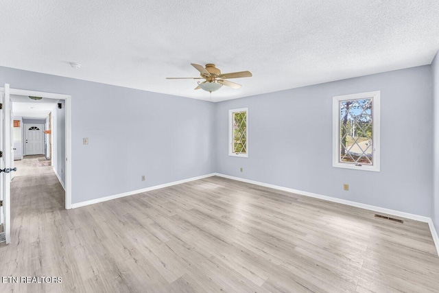 8305 Sharp Rd, Powell, TN 37849 - spare room featuring a textured ceiling, a ceiling fan, light wood finished floors, baseboards, and a smoke detector