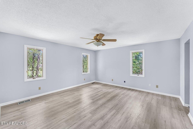 8305 Sharp Rd, Powell, TN 37849 - spare room featuring plenty of natural light, a textured ceiling, light wood finished floors, ceiling fan, and baseboards