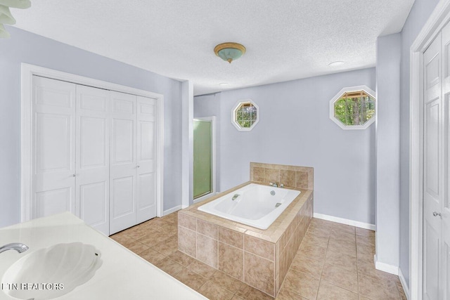 8305 Sharp Rd, Powell, TN 37849 - full bathroom with a sink, a bath, baseboards, tile patterned flooring, and a textured ceiling