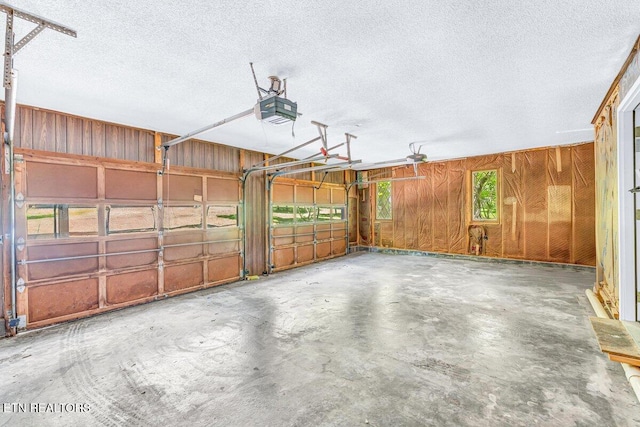 8305 Sharp Rd, Powell, TN 37849 - garage with a garage door opener and wooden walls
