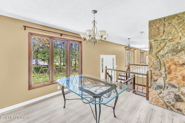 8305 Sharp Rd, Powell, TN 37849 - dining space featuring a chandelier, light wood-style floors, plenty of natural light, and a textured ceiling