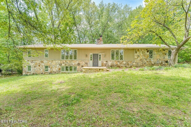 8305 Sharp Rd, Powell, TN 37849 - back of property featuring stone siding, a chimney, and a lawn