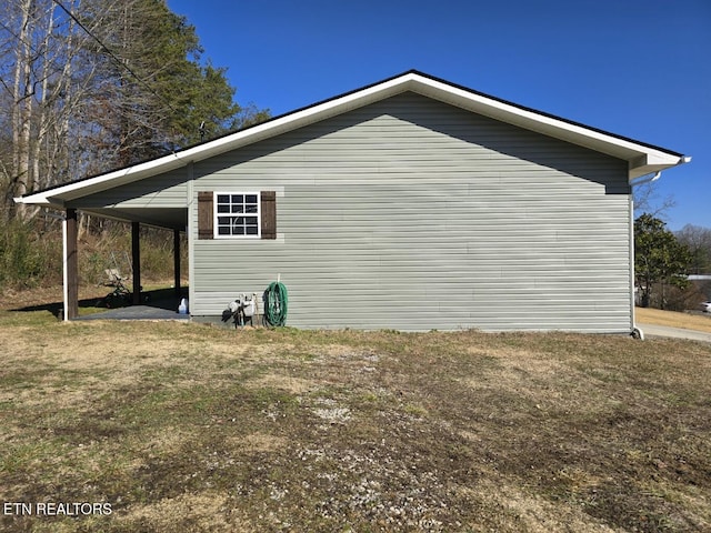 view of home's exterior featuring a carport and a yard