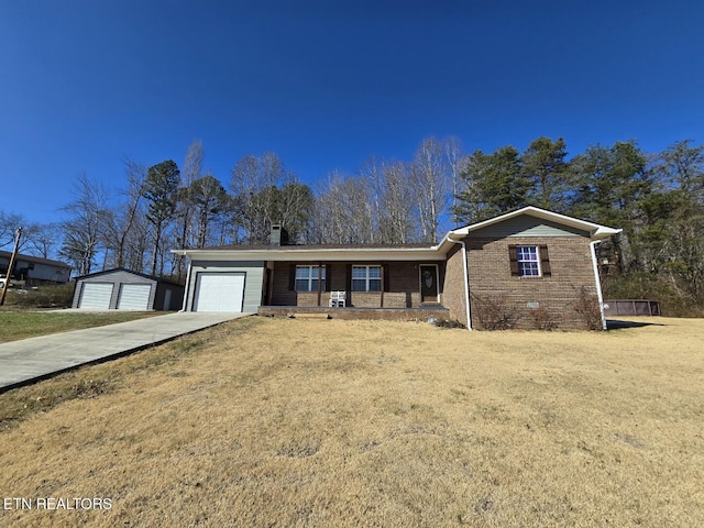 ranch-style home featuring a front lawn, a garage, and covered porch