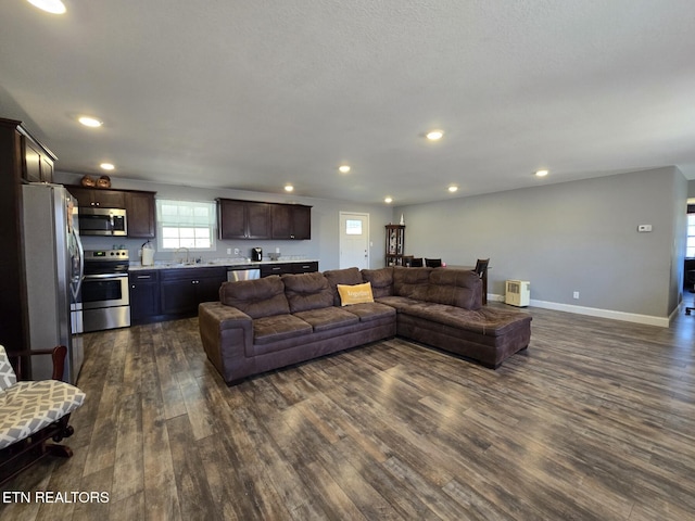 living room with dark hardwood / wood-style flooring and sink