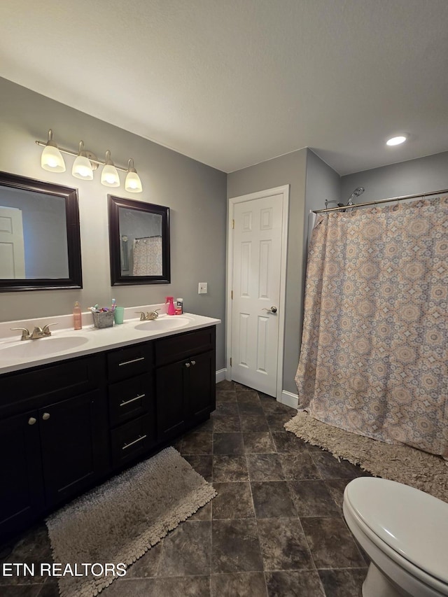 bathroom with toilet, a shower with shower curtain, and vanity