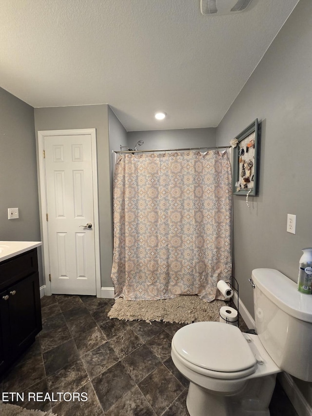 bathroom with toilet, vanity, a shower with shower curtain, and a textured ceiling