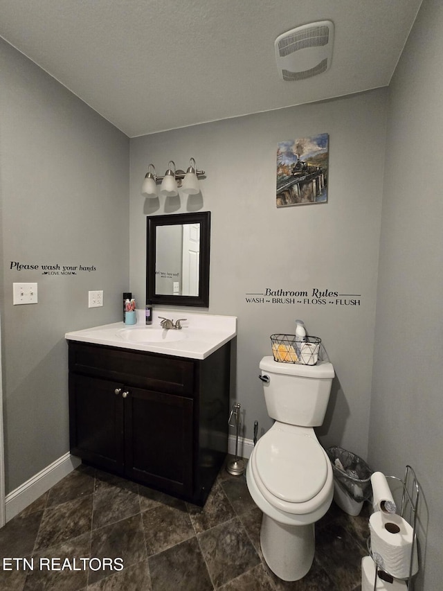 bathroom featuring toilet and vanity