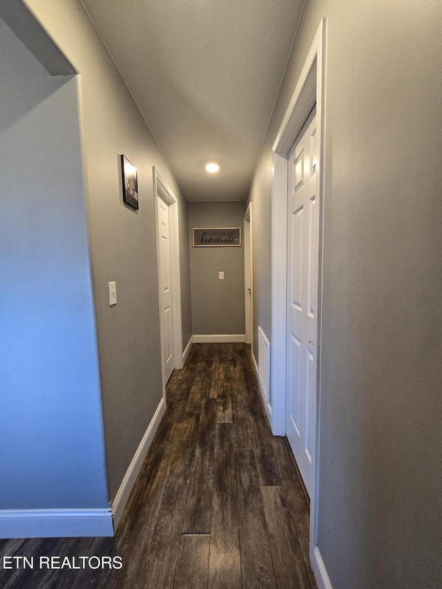 hallway with dark wood-type flooring