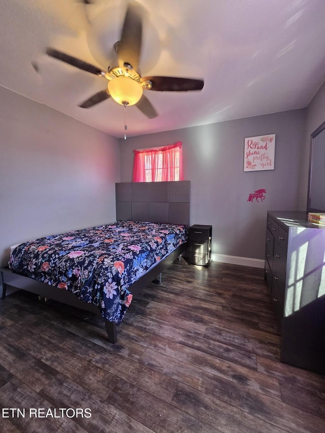 bedroom with ceiling fan and dark hardwood / wood-style floors