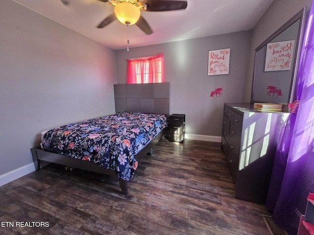 bedroom with ceiling fan and dark hardwood / wood-style floors