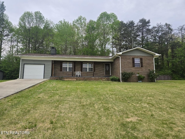 ranch-style house with a chimney, concrete driveway, brick siding, a front yard, and a garage
