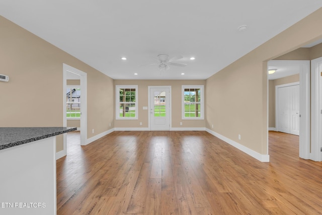 unfurnished living room with a ceiling fan, light wood-style flooring, recessed lighting, and baseboards