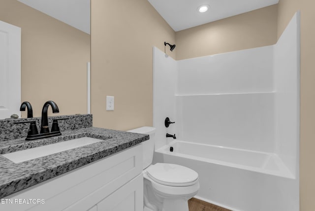 full bathroom with toilet, wood finished floors, tub / shower combination, and vanity