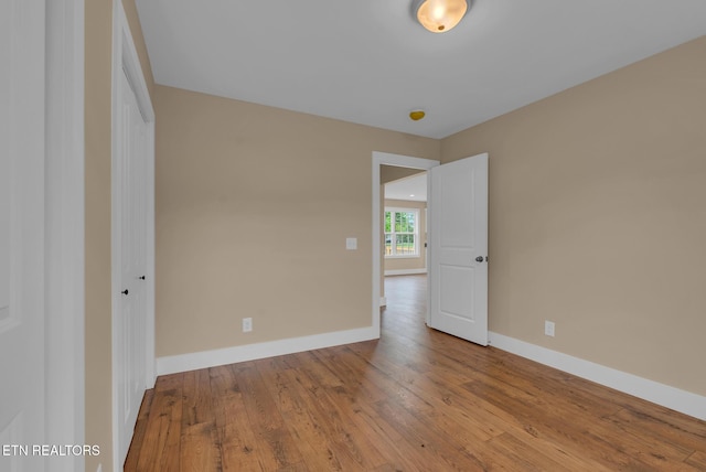 empty room featuring hardwood / wood-style floors and baseboards