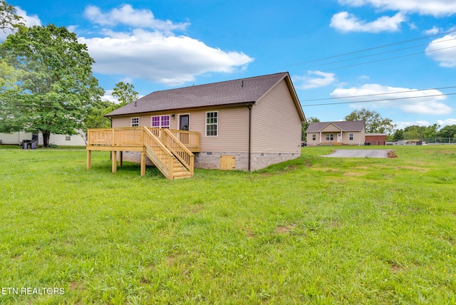 back of property with crawl space, a deck, a yard, and stairs