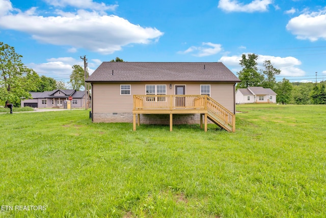 rear view of house featuring crawl space, a wooden deck, a lawn, and stairs