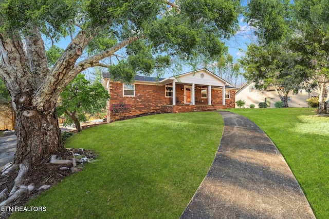 view of front of home with a porch and a front lawn