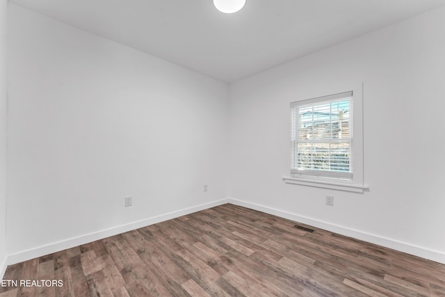 unfurnished room with hardwood / wood-style floors