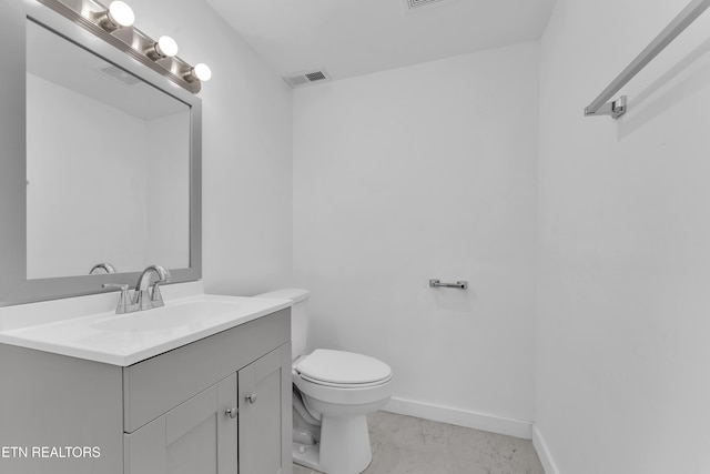 bathroom with toilet, tile patterned floors, and vanity