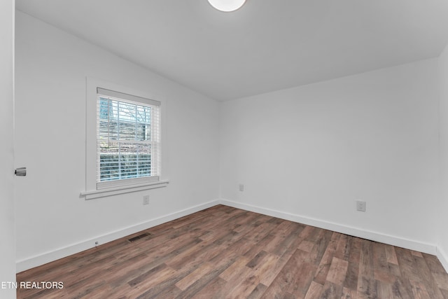 spare room with hardwood / wood-style flooring