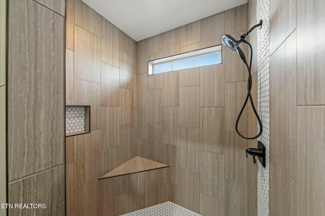 bathroom with tiled shower