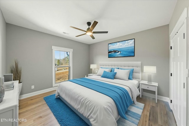 bedroom with ceiling fan and light hardwood / wood-style floors