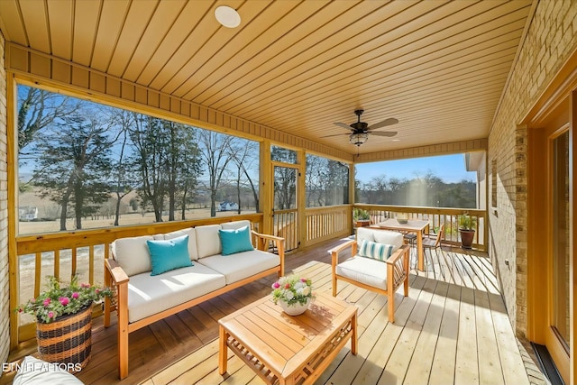 wooden terrace featuring ceiling fan and outdoor lounge area