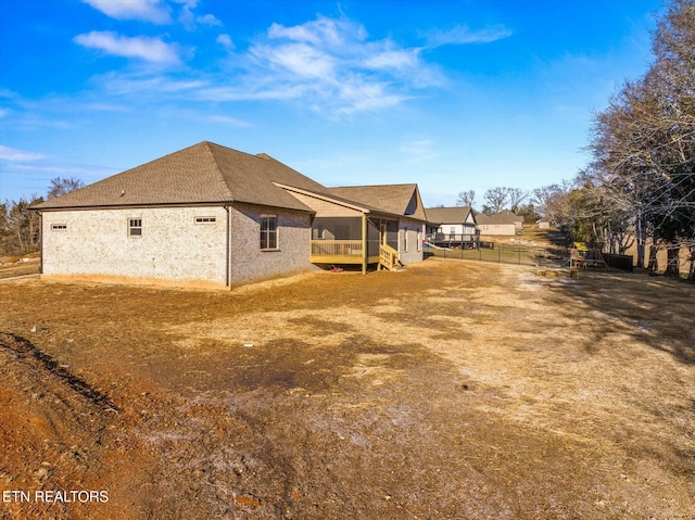 view of property exterior with a sunroom and a lawn