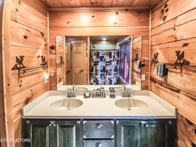 bathroom featuring wooden walls, wood ceiling, and vanity