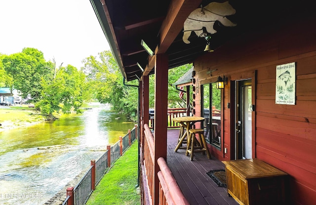 wooden deck featuring a water view