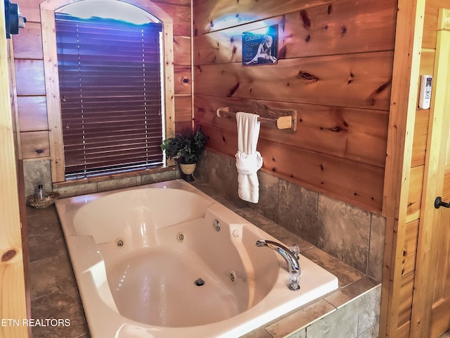 bathroom featuring tiled tub