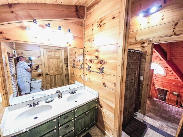 bathroom featuring wood walls and vanity