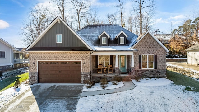 view of front of property featuring covered porch and a garage