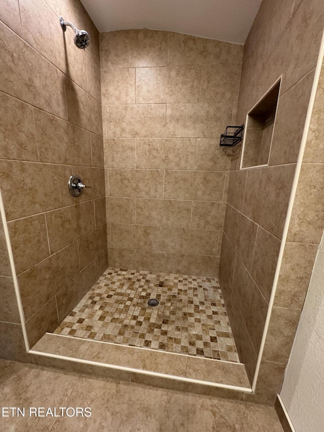 full bath featuring tiled shower