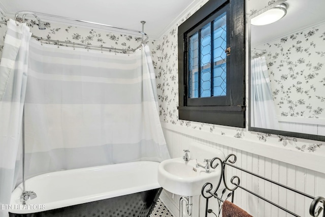 bathroom featuring ornamental molding, sink, and shower / bath combo